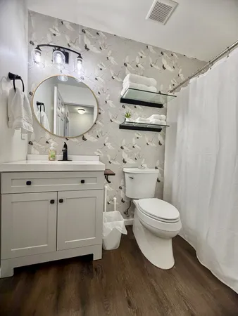 a bathroom with a toilet sink and mirror