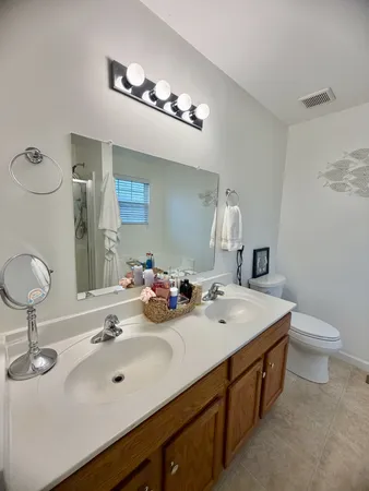 a bathroom with a double vanity sink and a mirror