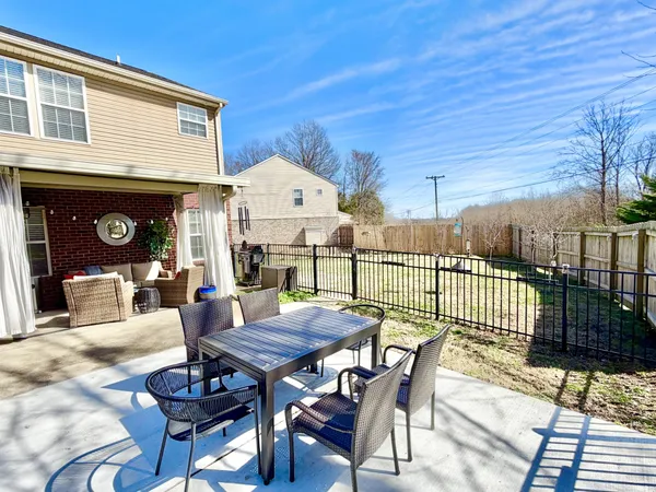 a view of a patio with a table and chairs