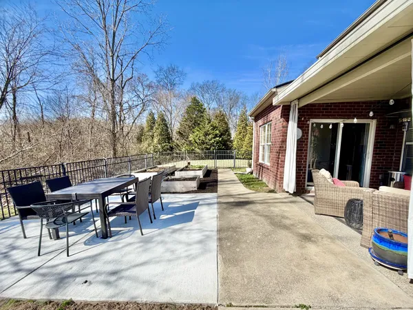 a view of a patio with table and chairs and potted plants