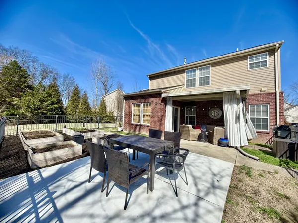 a view of a patio with dining table and chairs with wooden floor and fence
