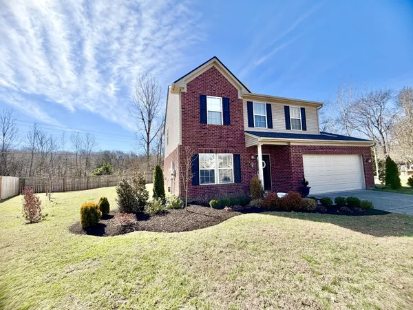 a front view of a house with a yard