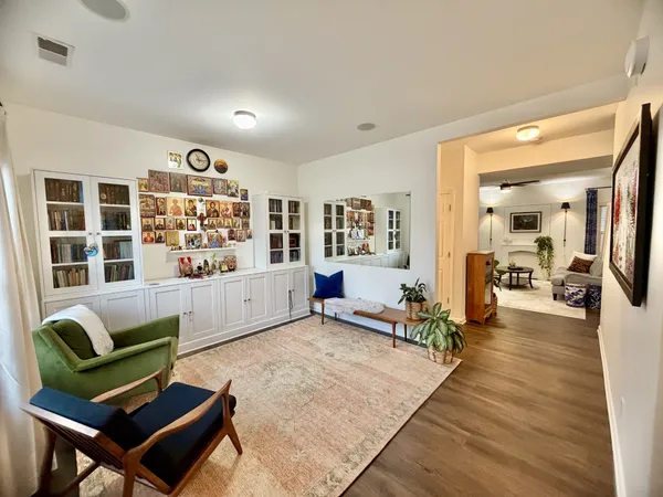 a living room with furniture and a wooden floor