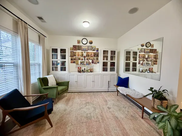 a living room with furniture windows and wooden floor