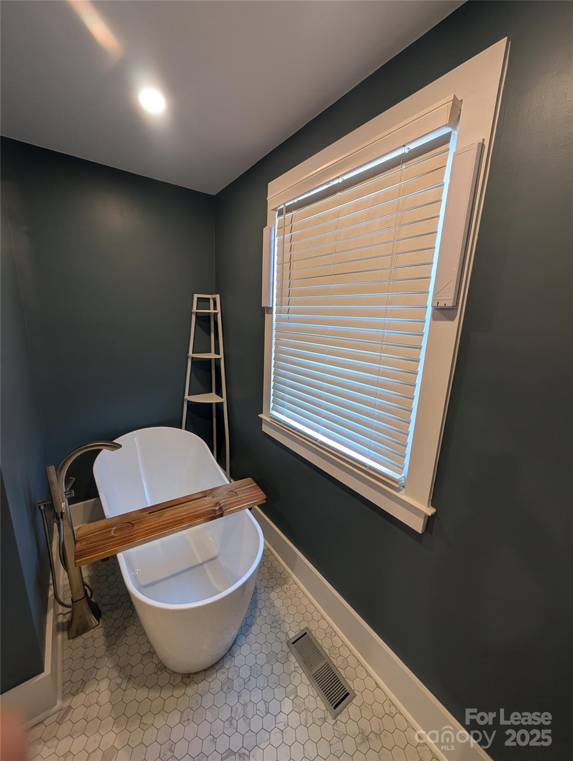 243 Woodland Road Tryon, NC 28782 - Photo 11 of 15 a bathroom with a toilet a sink and a window