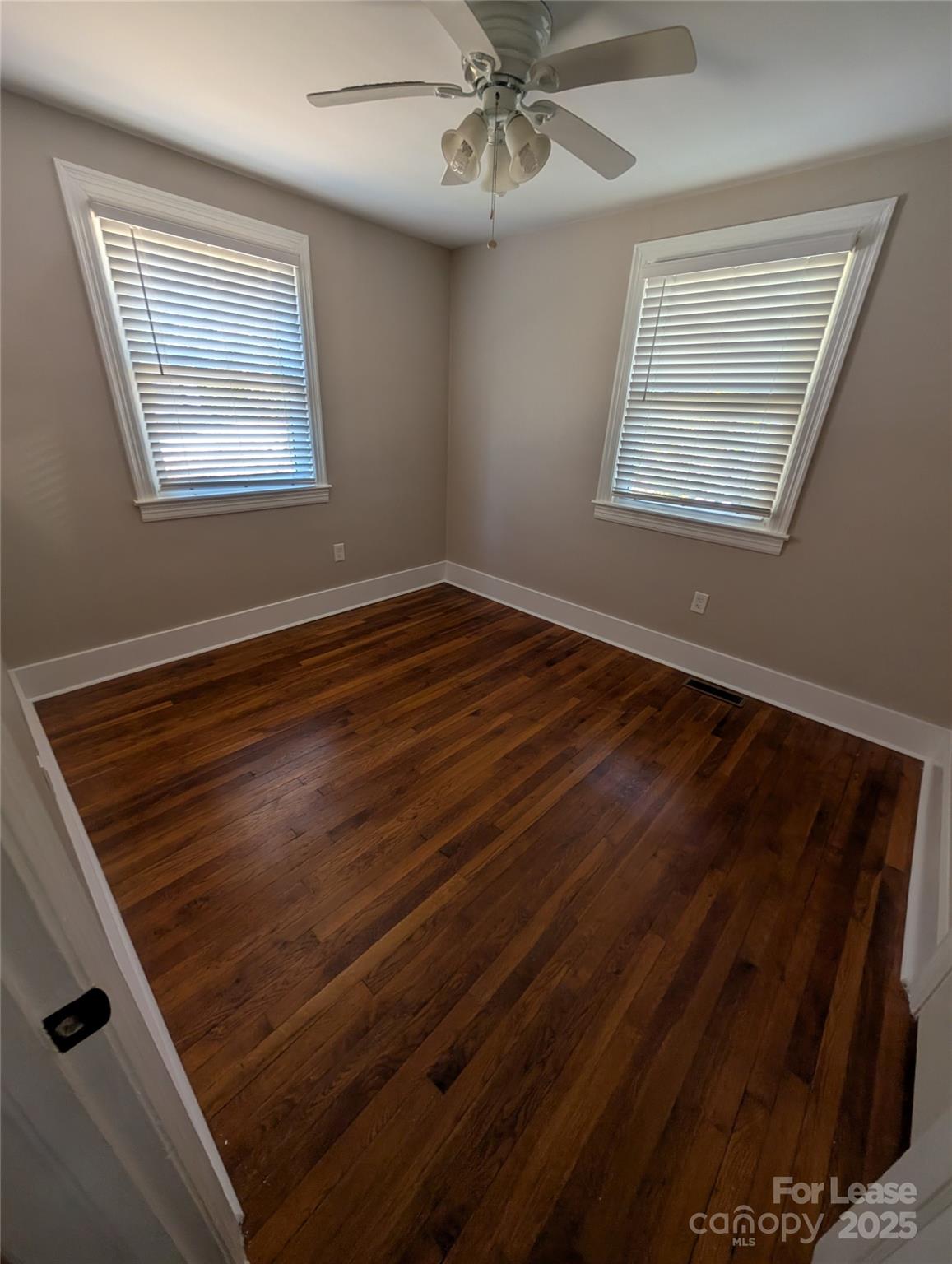 243 Woodland Road Tryon, NC 28782 - Photo 13 of 15 a view of an empty room with wooden floor and a window