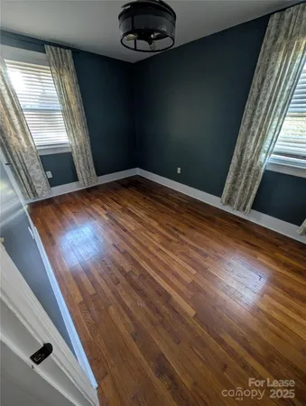en empty room with wooden floor