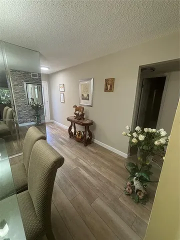 a living room with furniture and a mirror