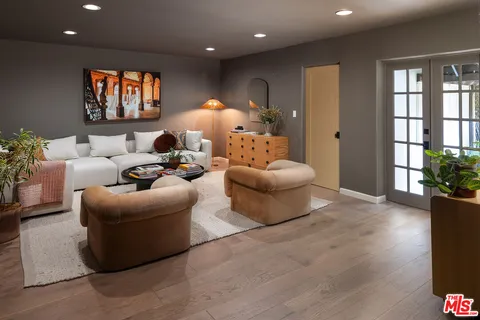 a living room with furniture and a potted plant
