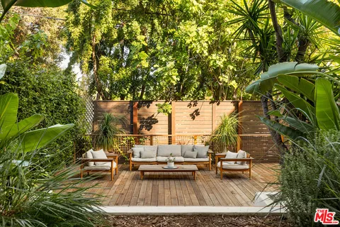 a view of roof deck with lawn chairs and couches