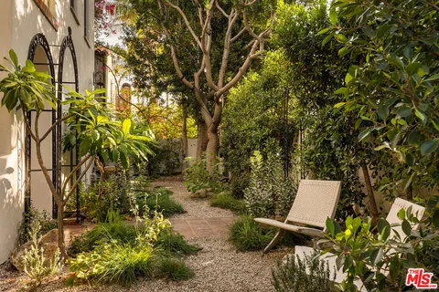a view of a bench in backyard of the house