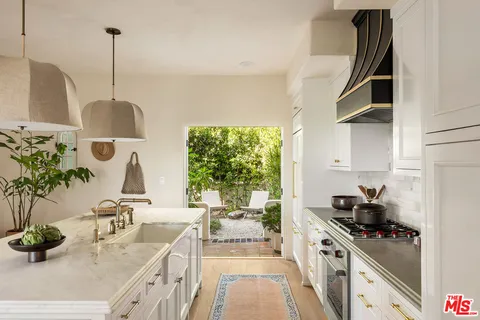 a kitchen with stove and cabinets