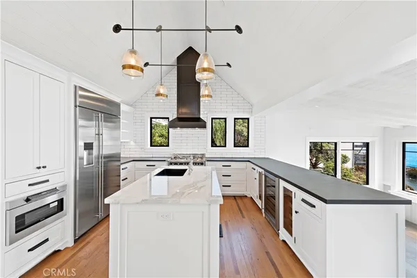 a kitchen with stainless steel appliances a stove sink and cabinets