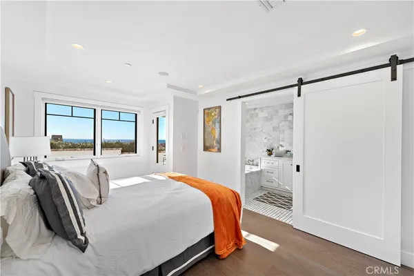a bathroom with a double vanity sink a mirror and a bathtub