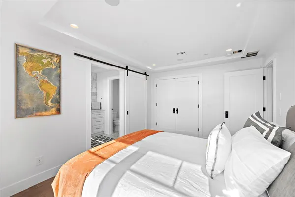 a bedroom with a bed window and potted plant