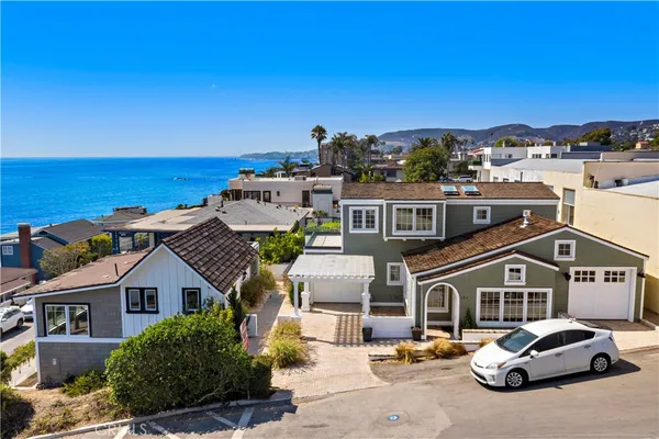 a view of a house with a small yard and plants