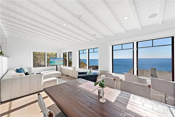 a living room with furniture and large windows