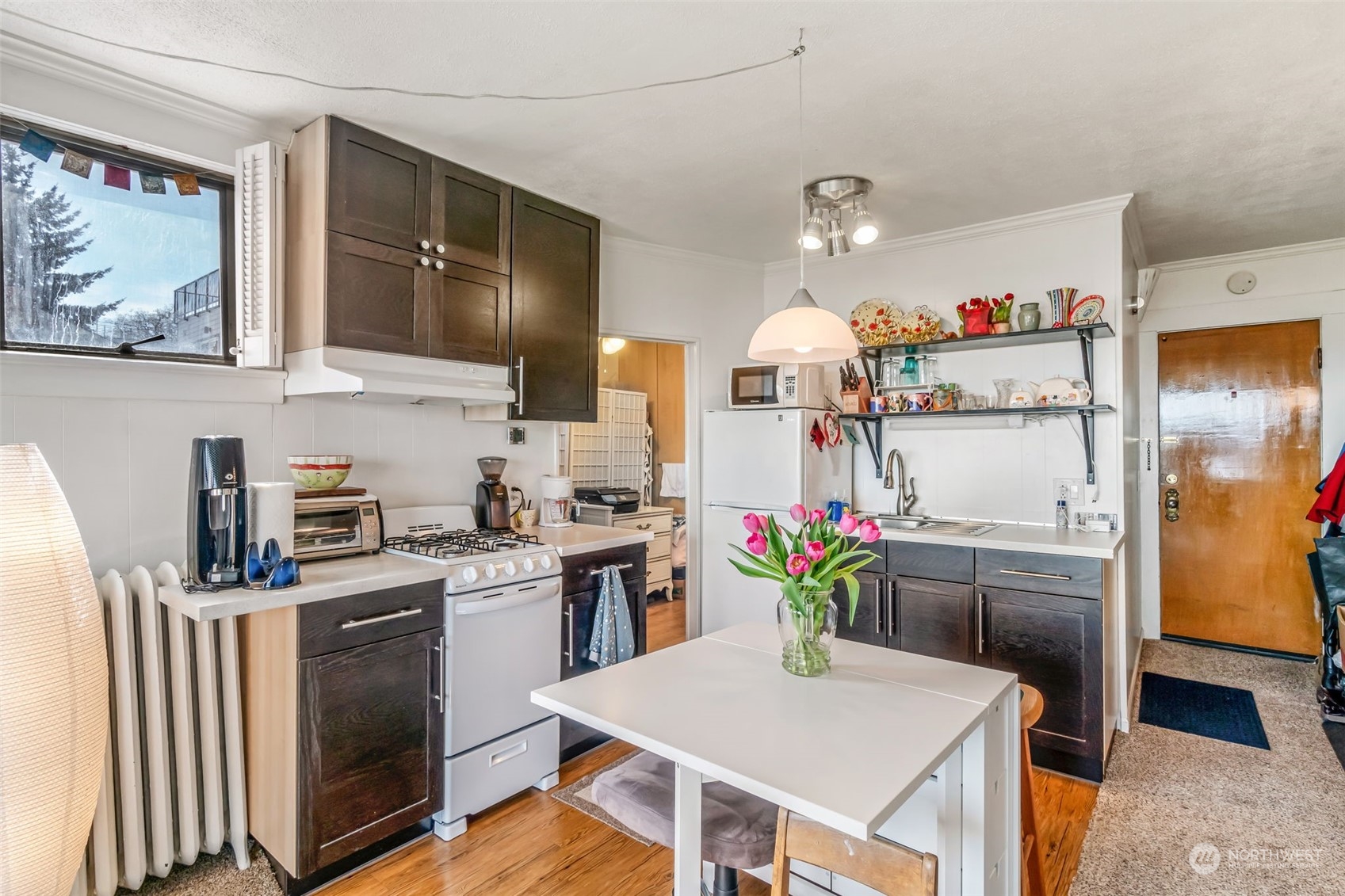 1330 California Avenue Southwest Seattle, WA 98116 - Photo 9 of 24 a kitchen with stainless steel appliances a sink stove and refrigerator