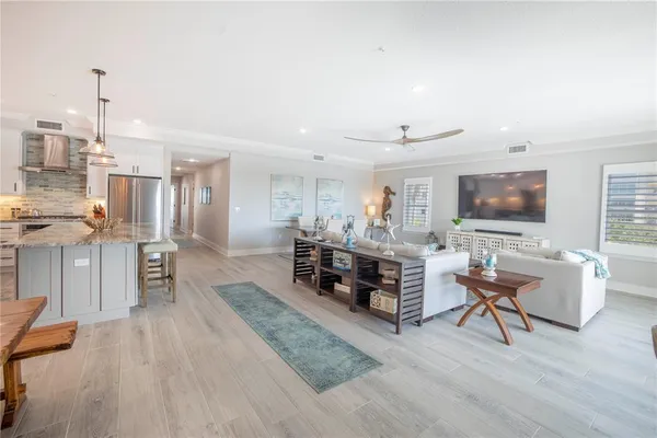 a living room with furniture tv and a flat screen tv