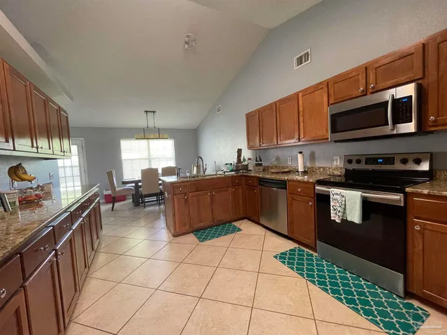 a kitchen with stainless steel appliances and cabinets