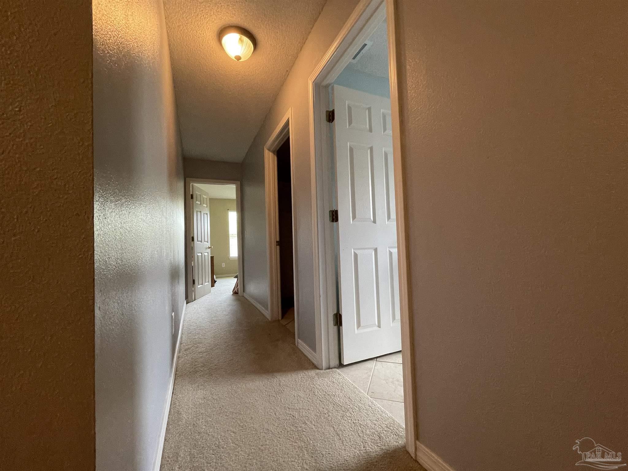 7025 Boo Lane Pensacola, FL 32526 - Photo 17 of 35 a view of a hallway with wooden floor