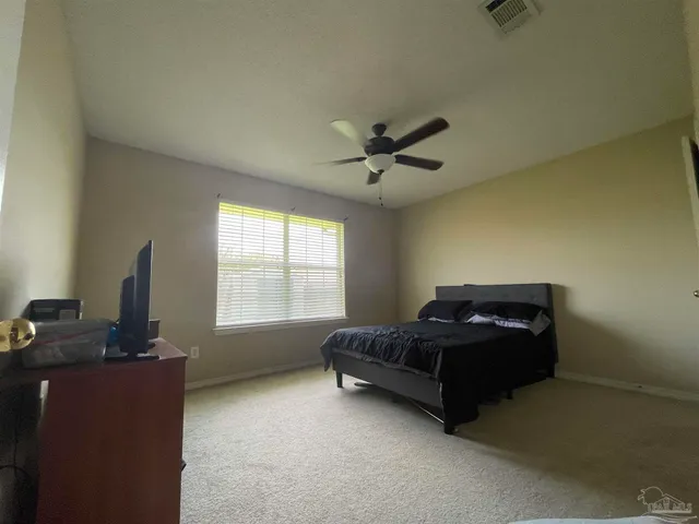 a living room with a bed furniture and a window