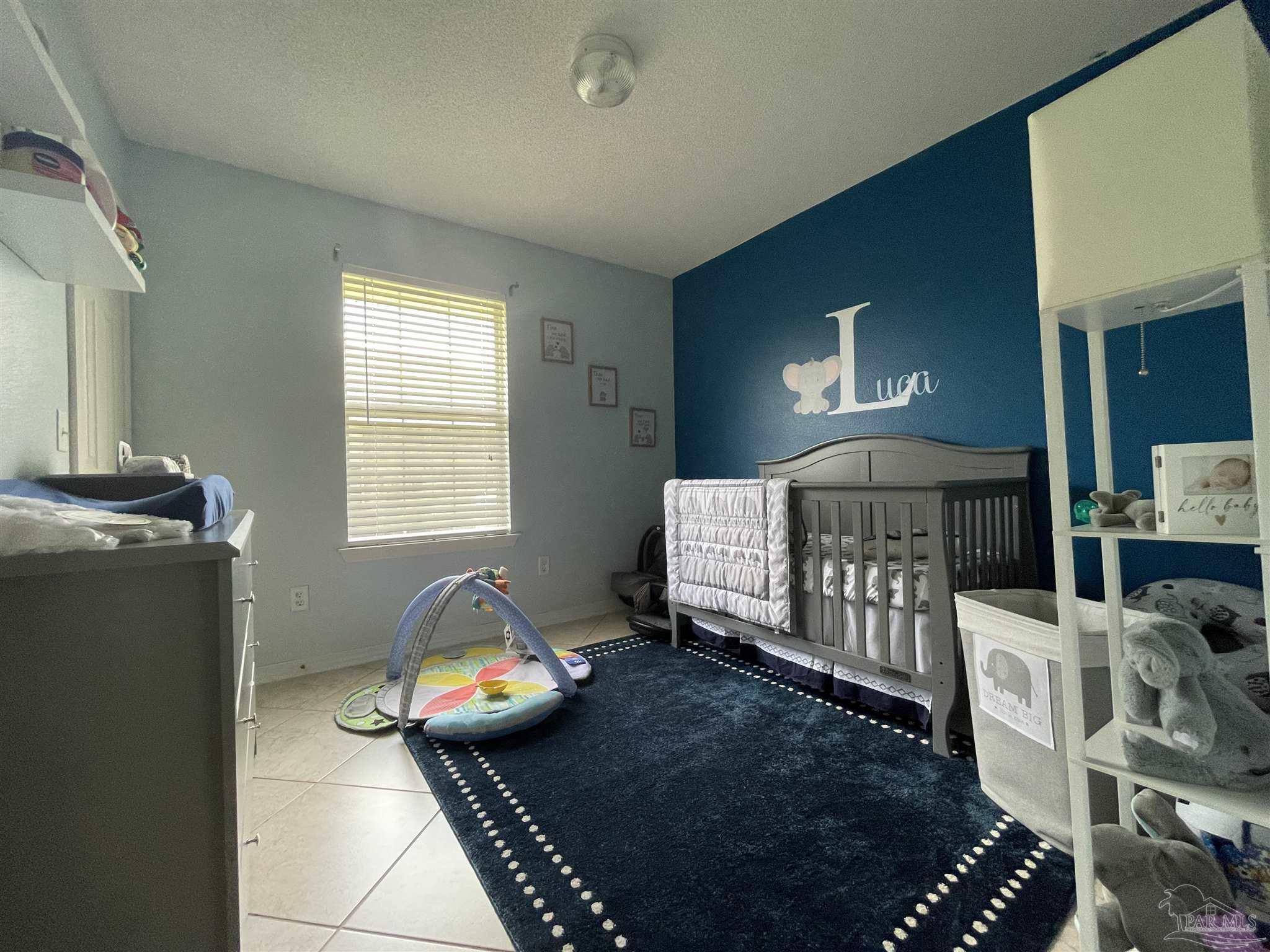 7025 Boo Lane Pensacola, FL 32526 - Photo 22 of 35 a bedroom with furniture and a window