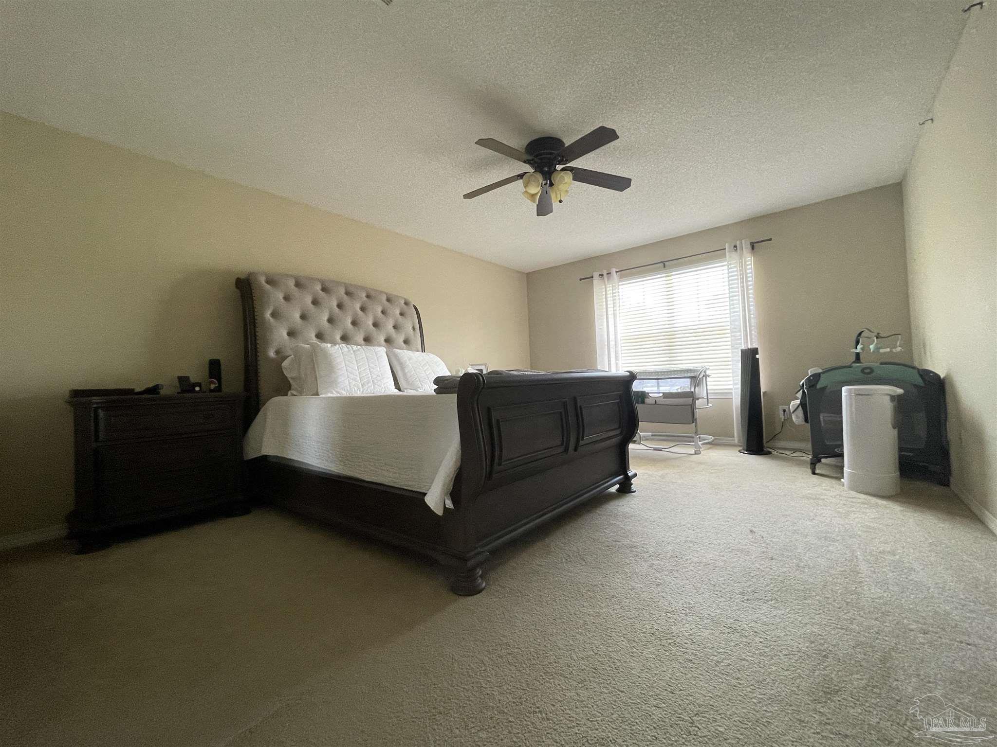 7025 Boo Lane Pensacola, FL 32526 - Photo 24 of 35 a spacious bedroom with a bed and window