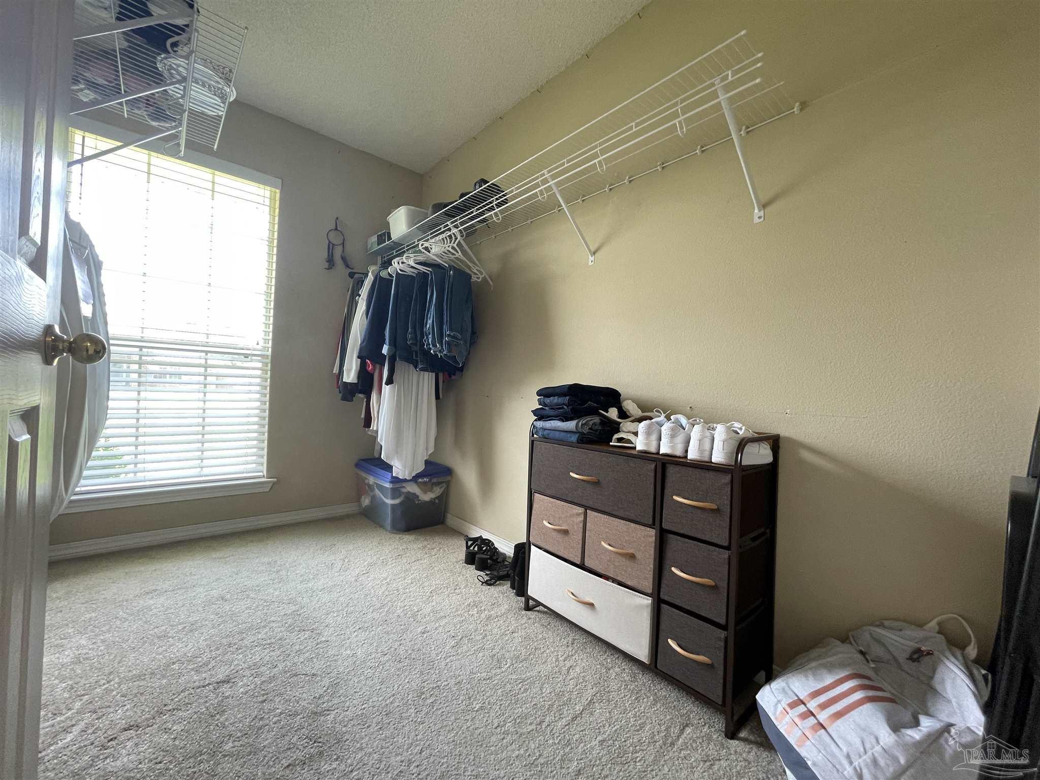 7025 Boo Lane Pensacola, FL 32526 - Photo 25 of 35 a bedroom with a bed and a window