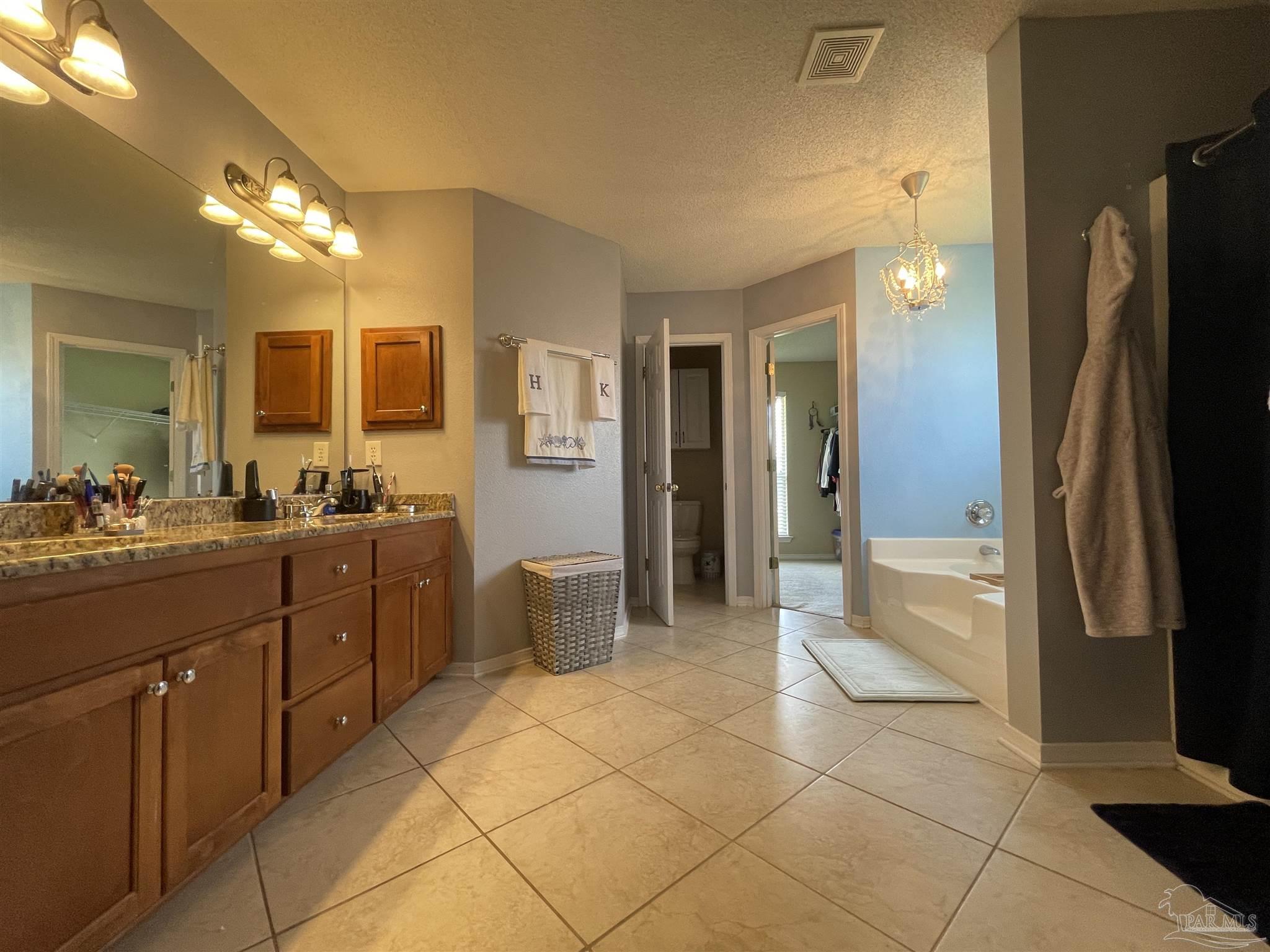 7025 Boo Lane Pensacola, FL 32526 - Photo 28 of 35 a bathroom with a sink a mirror and a shower