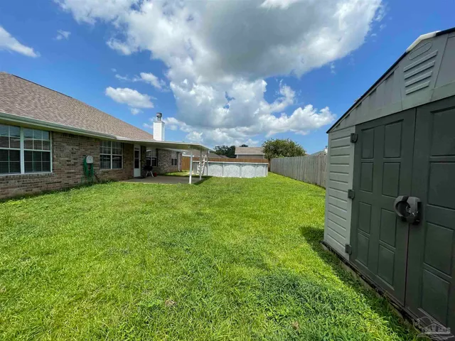 a view of a house with a yard and sitting area