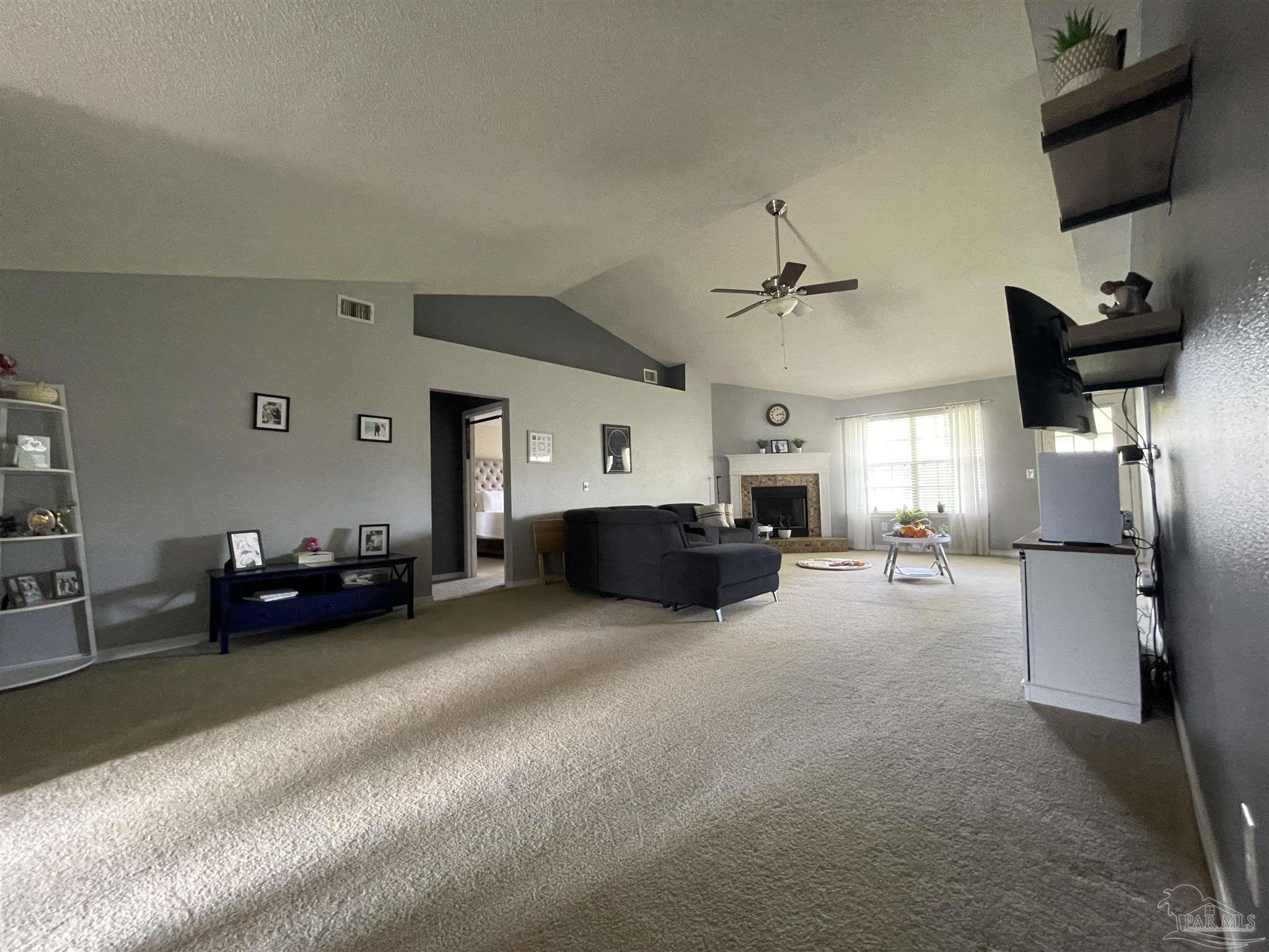 7025 Boo Lane Pensacola, FL 32526 - Photo 8 of 35 a living room with furniture and a flat screen tv