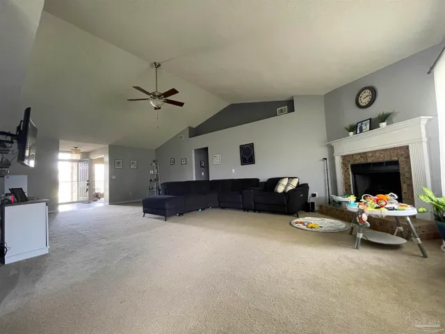 a living room with furniture and a fireplace