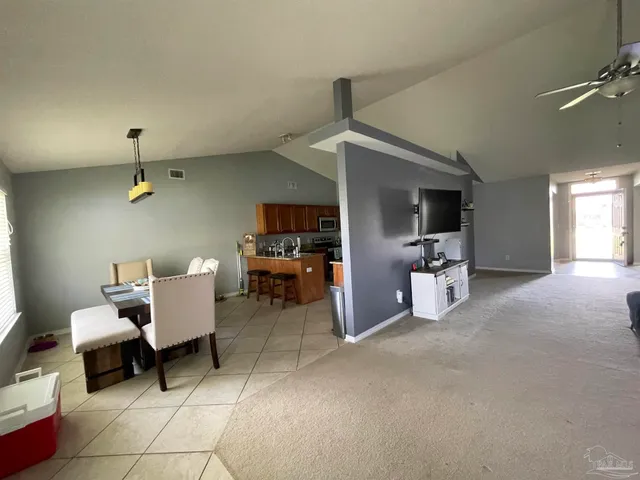 a room with furniture a flat screen tv and a fireplace