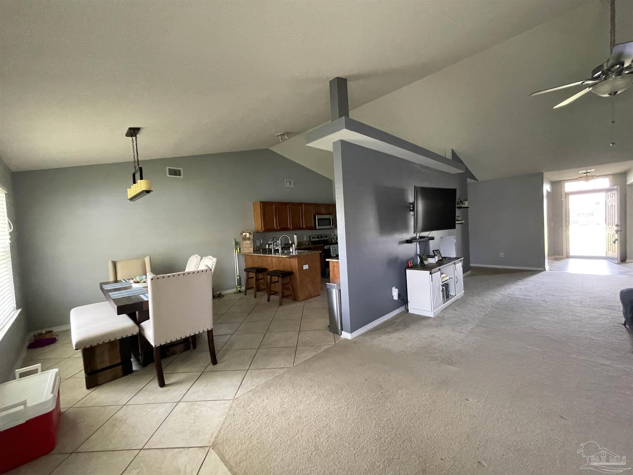 7025 Boo Lane Pensacola, FL 32526 - Photo 10 of 35 a room with furniture a flat screen tv and a fireplace