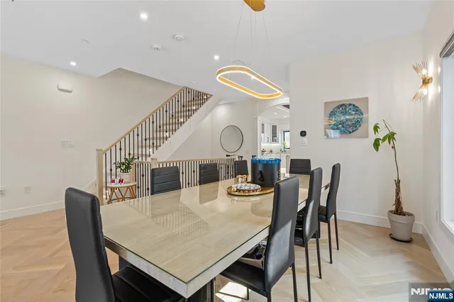 a view of staircase with lots of frames on wall and wooden floor