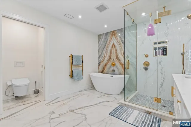 a large bedroom with a bed and a large mirror