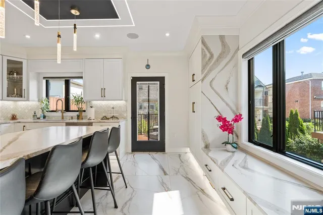 a view of a dining room with furniture and chandelier