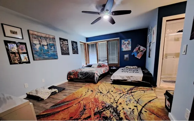 a bedroom with a large bed and a chandelier