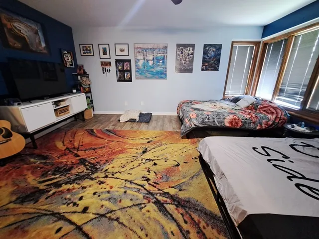 a bedroom with a bed and a flat screen tv