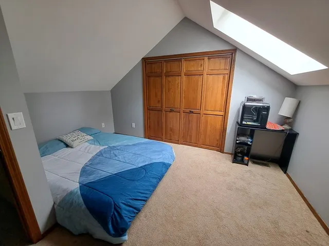 a bedroom with a bed and furniture