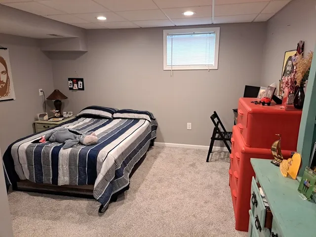 a bedroom with a bed and a desk