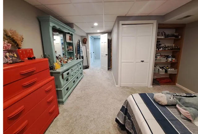 a hallway with a couch and dresser