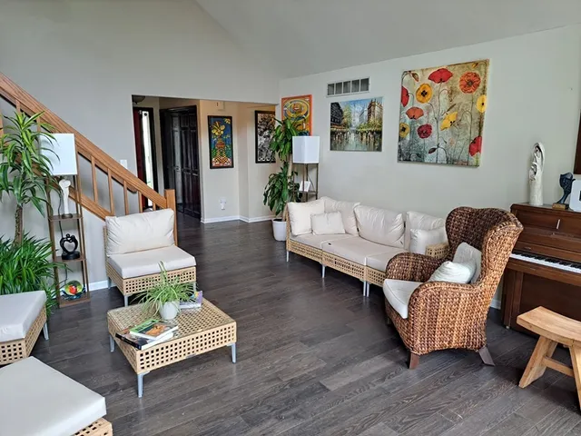 a living room with furniture and wooden floor