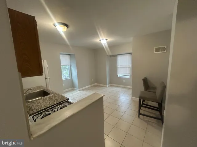 a kitchen with granite countertop cabinets and stove top oven