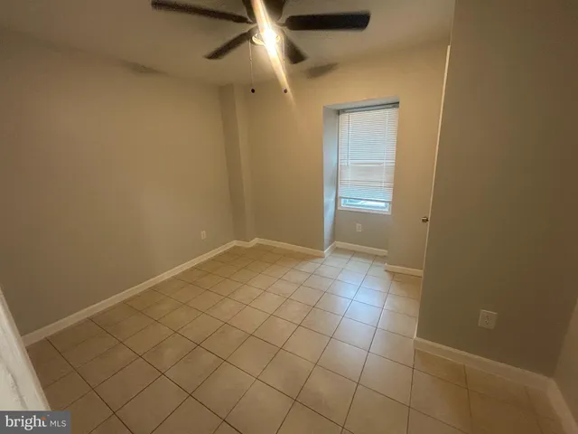 a kitchen with refrigerator and chairs