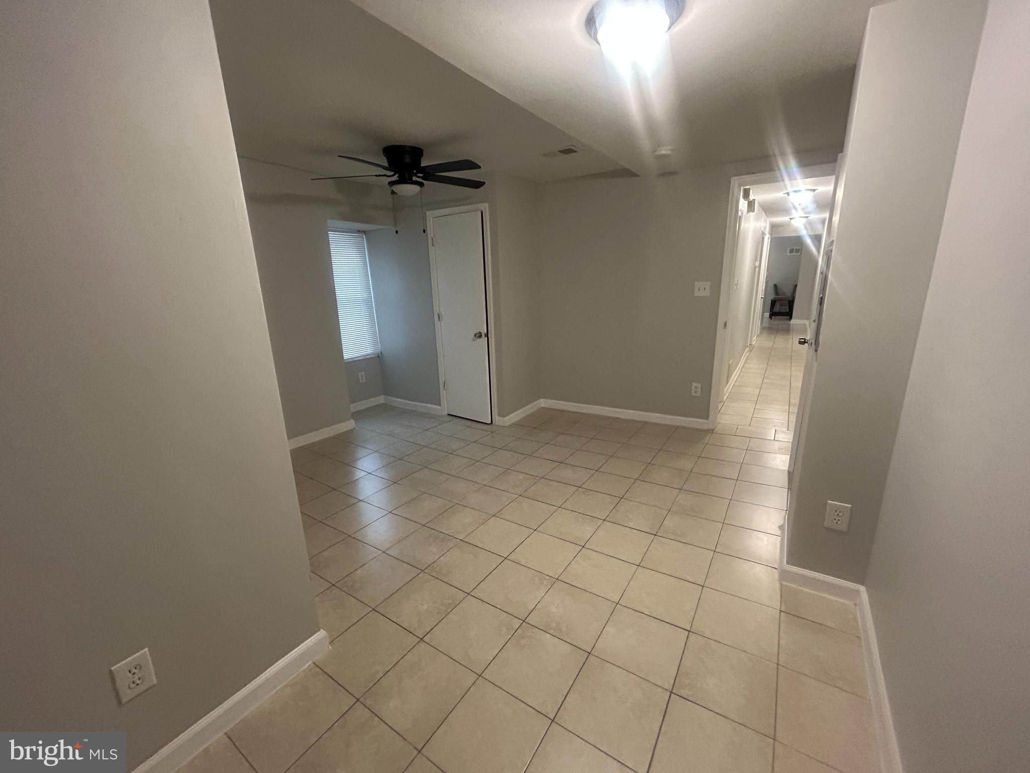 531 Brinton Street, Unit 3 Philadelphia, PA 19144 - Photo 9 of 9 an empty room with white walls and tiles