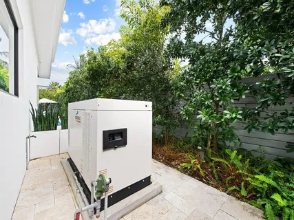 a view of washer and dryer with tree in front of it
