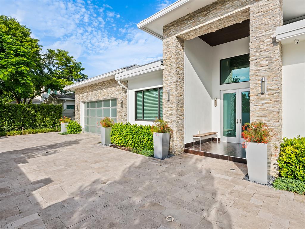 1710 Middle River Drive Fort Lauderdale, FL 33305 - Photo 15 of 47 front view of a house with a small yard
