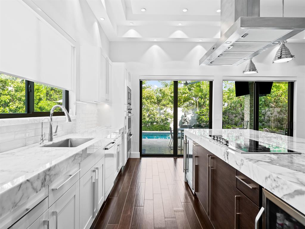 1710 Middle River Drive Fort Lauderdale, FL 33305 - Photo 18 of 47 a large kitchen with kitchen island a large window in it